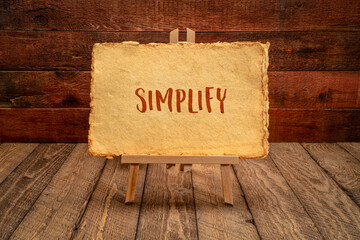 simplify reminder, pragmatic, declutter or get organized concept, inspirational handwriting on a...