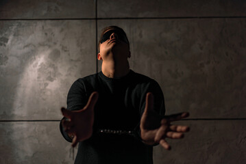 man in mask and handcuffs in dark out of focus
