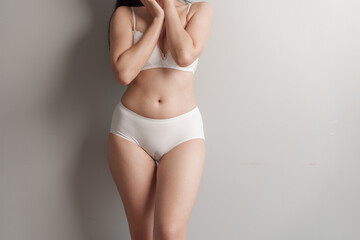 Close-up beauty asian woman in white bra and panties isolated over white background.