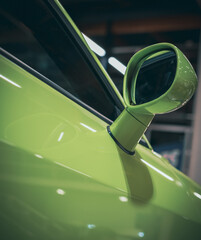 side rear-view mirror on a modern green car