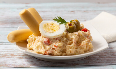 Russian salad. Typical Spanish tapa on a white plate.