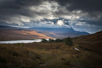 A dramatic autumnal HDR of Ben Hope partially covered by low cloud, with Loch Hope below, Sutherland, Scotland.