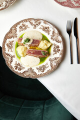 grilled tuna steak with mashed potatoes and gravy on a beautiful plate