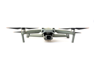 Drone quadcopter with digital camera and sensors flying isolated on white background.