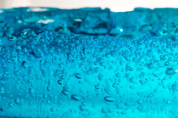 small bubble floating in blue gel like under the ocean.