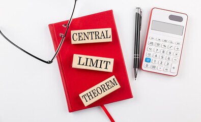 CENTRAL LIMIT THEOREM text on wooden block on red notebook