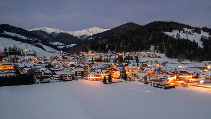winter landscape, Dobbiaco Toblach, Bolzano, Italy. Aerial drone shot in january, Aerial view of beautiful alpin mountain town, christmas time , city with lights
