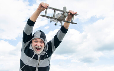 free senior man on sky background. senior man at retirement. senior retired man with toy plane