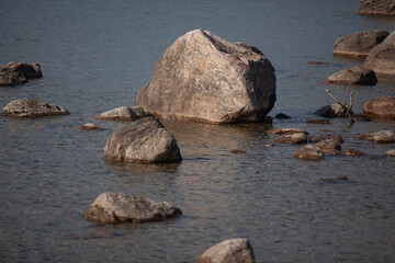 Large rocks along the shore of the water.