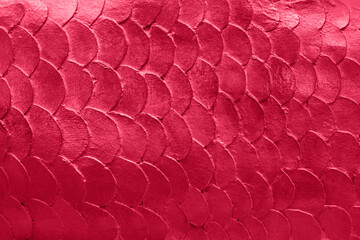 Close up pattern of mermaid or fish scales tiles toned in trendy color of the 2023 year Viva Magenta © Ivanna