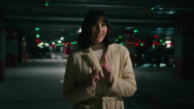 Happy dancing cheerful woman carefree winner lady female car buyer owner of new automobile rejoice about purchase prize dance to music having fun win at parking lot winning victory move at underground