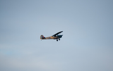 TW511 Auster 5 G-APAF vintage army liaison and observation aircraft ascending in a blue grey autumn sky, Wiltshire UK