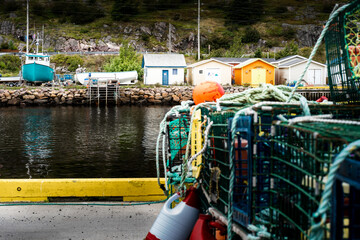 Lobster traps and Crab traps stacked on a boat dock at a small harbour village in the maritimes.