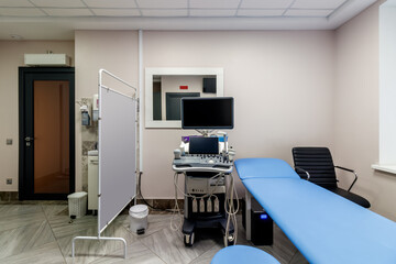 banner with empty medical office with ultrasound machine and blue couch. patient waiting