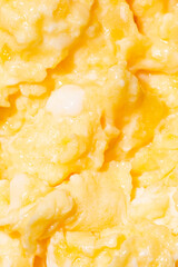 Texture of tasty scrambled eggs as background, closeup. Macro photo.