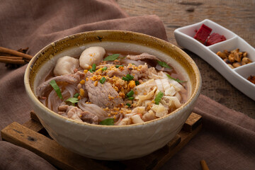 Noodles with pork and meatball in red soup (Look Chin Moo Nam Daeng).Thai street food