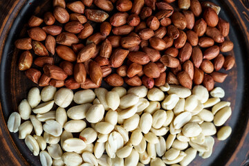 Raw peanuts in a clay bowl. Cajour and shelled beans