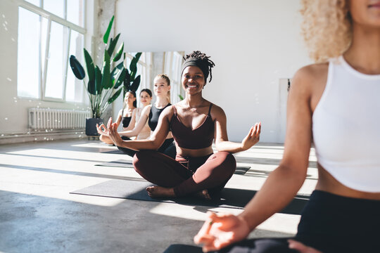Diverse women meditating in yoga class