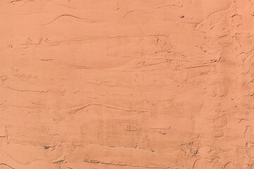 Light brown plaster wall with abstract stucco pattern texture surface background