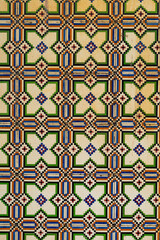 Fragment of building wall with floral ceramic wall tiles Azulejo Abstract decorative background textured ornate pattern. Traditional ornate Portuguese architecture