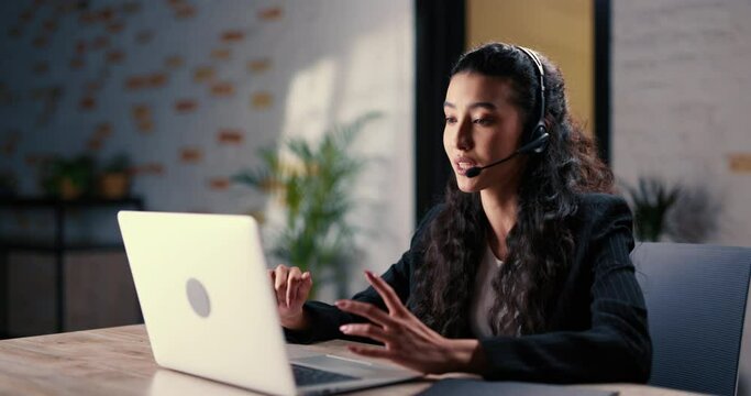 Woman remotely communicates with customers and presents the services of the company. The general sales manager builds contact and offers organization services to the client in order to close the deal.