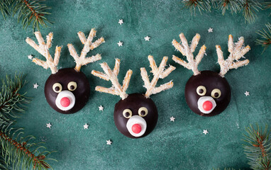 DIY New Year's treats for children, reindeers from cookies, marshmallows, chocolate and coconut...