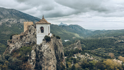 Fototapeta na wymiar Bell tower of mountain village located on high rocks