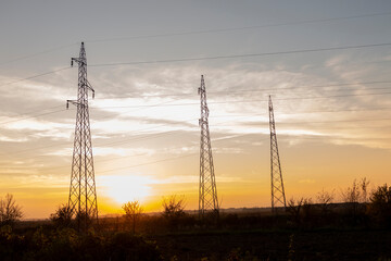 	
High voltage power lines at sunset.In future - scarcity of electricity. Due to high prices...