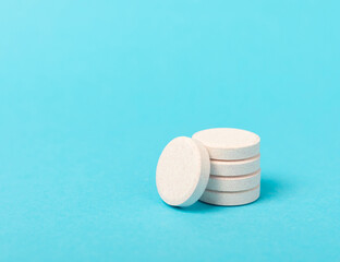 Multivitamin effervescent tablets. Soluble tablets of vitamin C. Calcium vitamin. Effervescent vitamin on a blue background. Medicine concept. Immunity.Place for text.