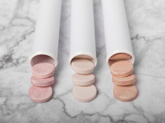 Multivitamin effervescent tablets. Soluble tablets of vitamin C. Calcium vitamin. Effervescent vitamin on a marble background. Medicine concept. Immunity.Place for text.