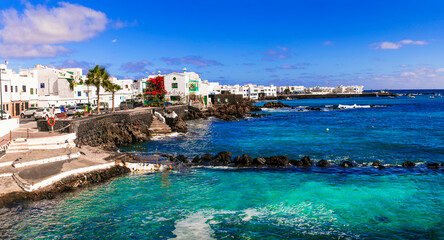 Lanzarote scenic places. view of Punta Mujeres traditional fishing village with crystal sea and white houses. popular  for natural swim pools. Canary islands travel