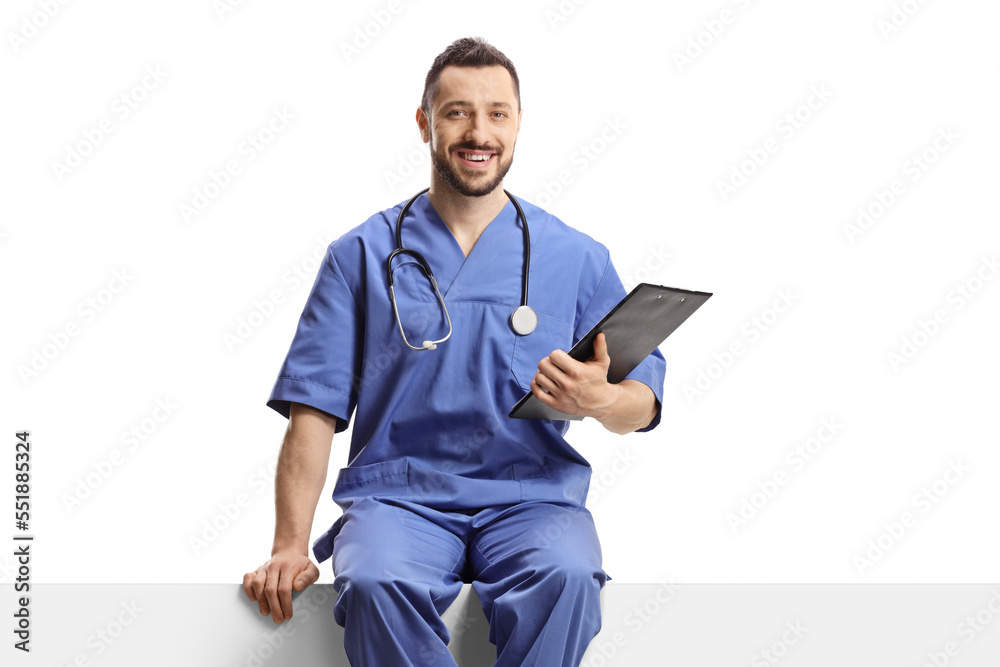 Wall mural Helath care worker in a blue uniform sitting on a blank panel