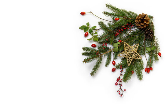 Natural floral christmas corner, greetings background - rustic decoration of  green spruce, barberry twigs and wild rose fruits with golden star, flat lay, copy space
