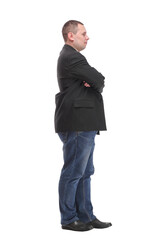 Side view of confident businessman with arms folded against white background