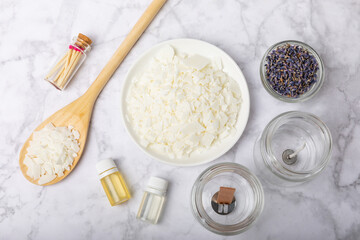 Basic set for homemade natural white eco-friendly soy wax candles in glass, wick, perfume on white marble. Hobby, business. Making candles with your own hands.Vegan product. Copy space.