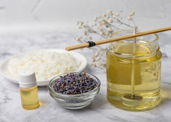 Basic set for homemade natural white eco-friendly soy wax candles in glass, wick, perfume on white marble. Hobby, business. Making candles with your own hands.Vegan product. Copy space.