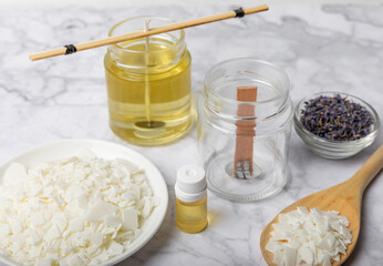 Basic set for homemade natural white eco-friendly soy wax candles in glass, wick, perfume on white marble. Hobby, business. Making candles with your own hands.Vegan product. Copy space.