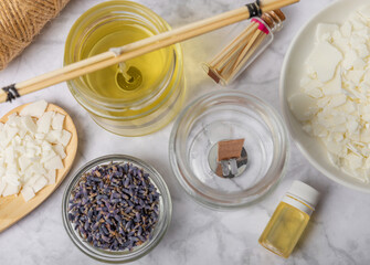 Basic set for homemade natural white eco-friendly soy wax candles in glass, wick, perfume on white marble. Hobby, business. Making candles with your own hands.Vegan product. Copy space.
