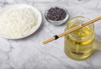 Basic set for homemade natural white eco-friendly soy wax candles in glass, wick, perfume on white marble. Hobby, business. Making candles with your own hands.Vegan product. Copy space.