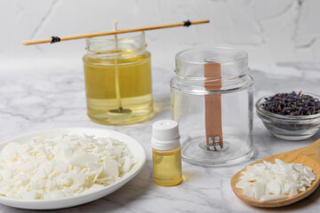 Basic set for homemade natural white eco-friendly soy wax candles in glass, wick, perfume on white marble. Hobby, business. Making candles with your own hands.Vegan product. Copy space.