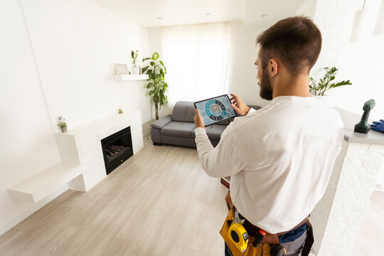 Smiling young caucasian male worker with tablet during work in kitchen