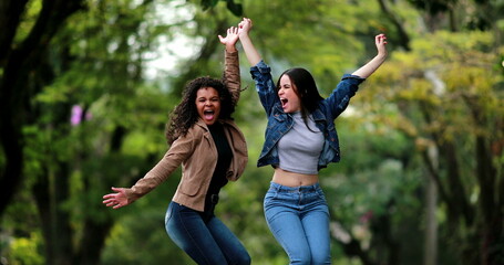 Enthusiastic fun girls jumping in the air