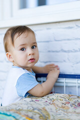 Little toddler boy close up in his house. Handsome toddler portrait. Joyful childhood and parenthood.