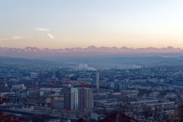 Aerial view over City of Zürich on a beautiful sunny autumn evening with lake and Swiss Alps in the background. Photo taken December 6th, 2022, Zurich, Switzerland.