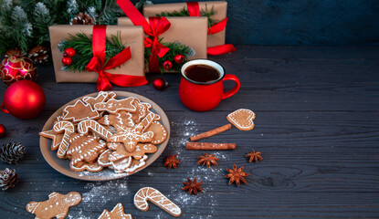 Traditional homemade gingerbread cookies and a cup of coffee among the Christmas decor. Christmas...