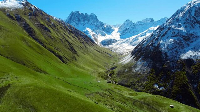 Drone view of a majestic snowy green scenic mountain valley in Juta in Georgia country