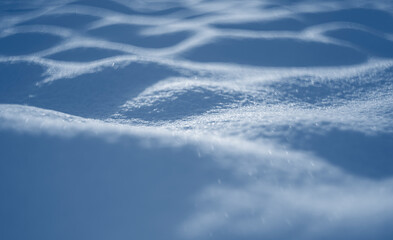 winter snow background - snow covered surface and artistic bokeh