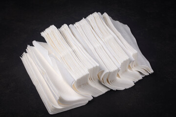 Paper napkins on a dark table.