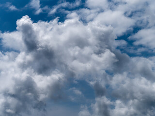 Blue sky with white cumulus clouds, background. White clouds and blue sky