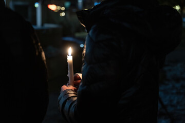 A person holding a candle at night